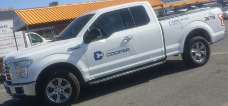 Sample CarGo still: a white Ford F-150 arriving at a job site
