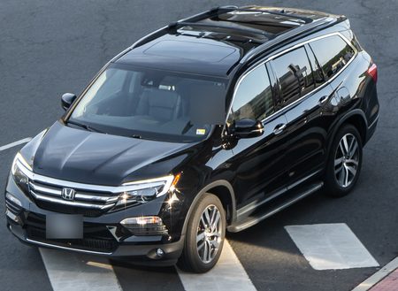 Sample CarGo still: a black Honda Pilot at a residential crosswalk, plate and driver blurred
